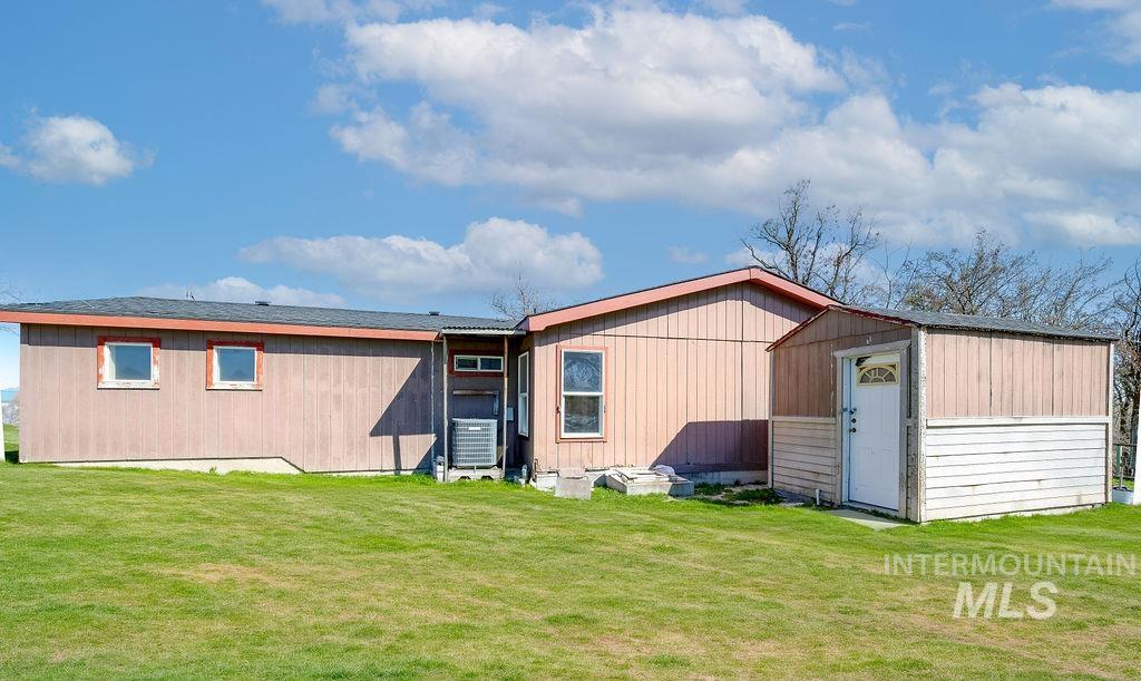 7370 Sagebrush Lane Caldwell, ID 83607 - Photo 28 of 40 Rear view of house with a shed and a yard