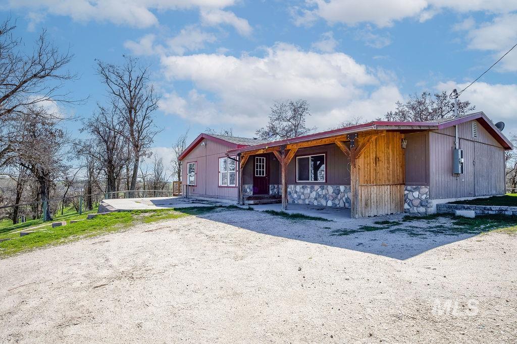 7370 Sagebrush Lane Caldwell, ID 83607 - Photo 29 of 40 View of front of home with stone siding, a porch, and a patio area