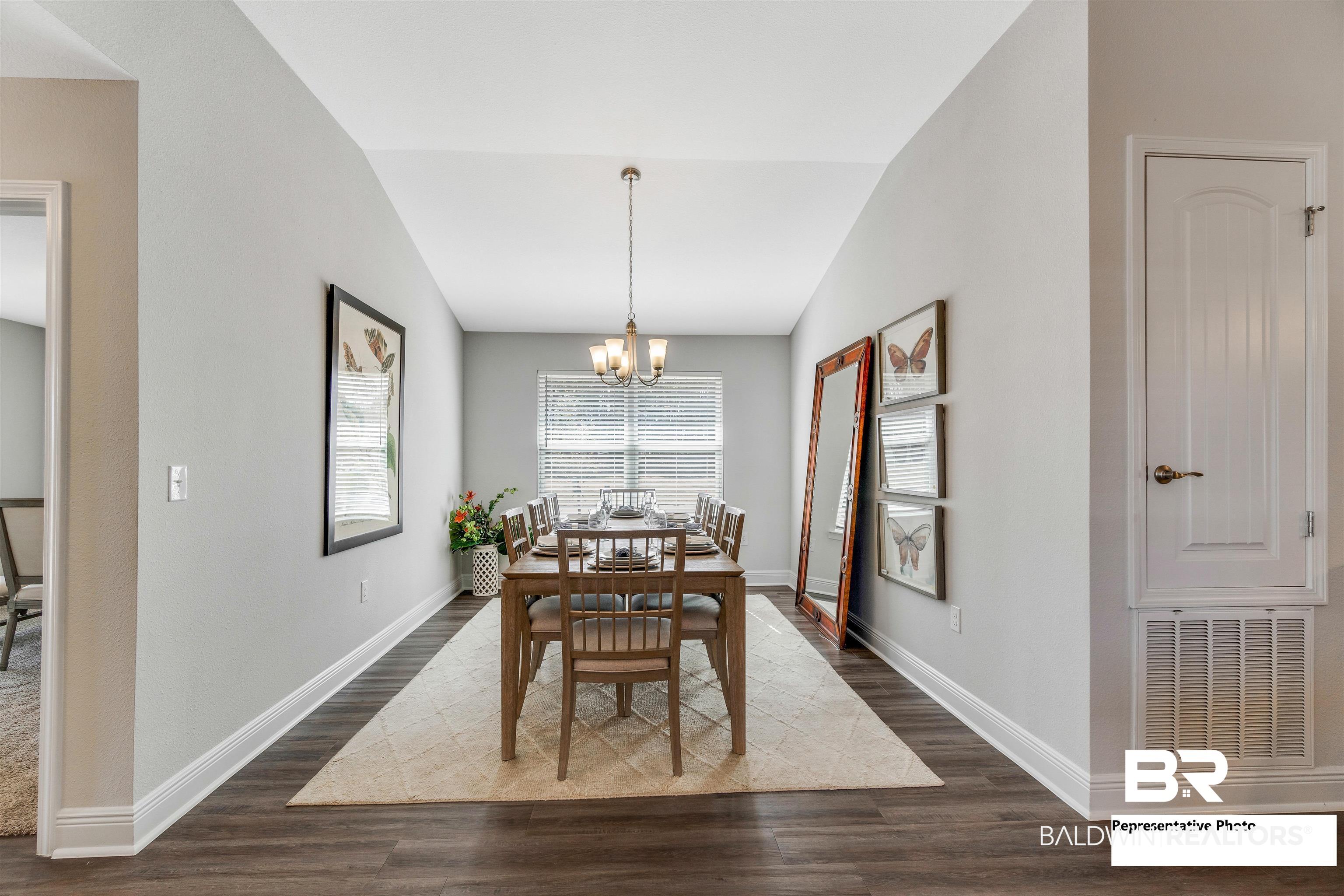 643 Mayflower Drive Foley, AL 36535 - Photo 11 of 34 Dining room with baseboards, visible vents, dark wood finished floors, an inviting chandelier, and vaulted ceiling