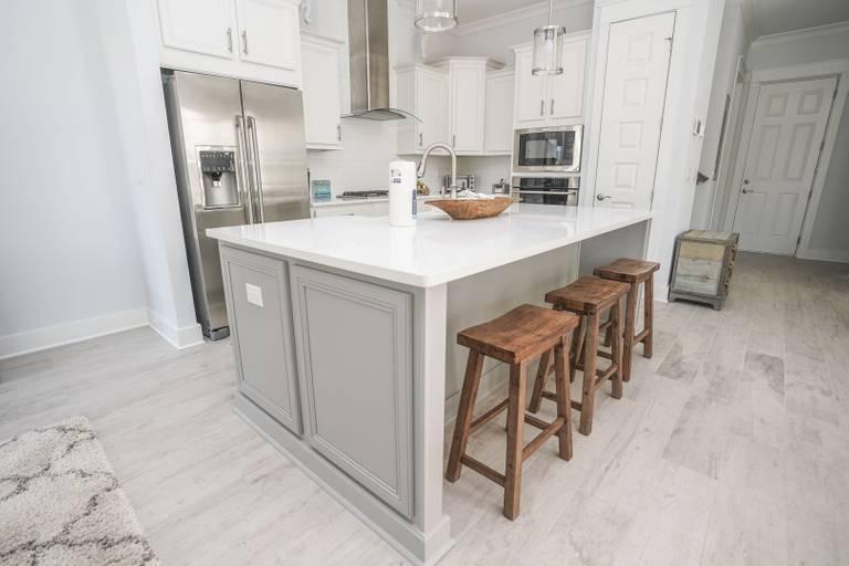 249 Milestone Dr Inlet Beach, Unit A Inlet Beach, FL 32461 - Photo 5 of 18 a kitchen with stainless steel appliances a sink and cabinets