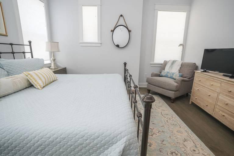 249 Milestone Dr Inlet Beach, Unit A Inlet Beach, FL 32461 - Photo 8 of 18 a bedroom with furniture and a flat screen tv