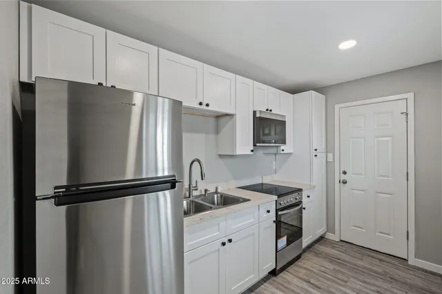 a kitchen with a refrigerator stove and sink