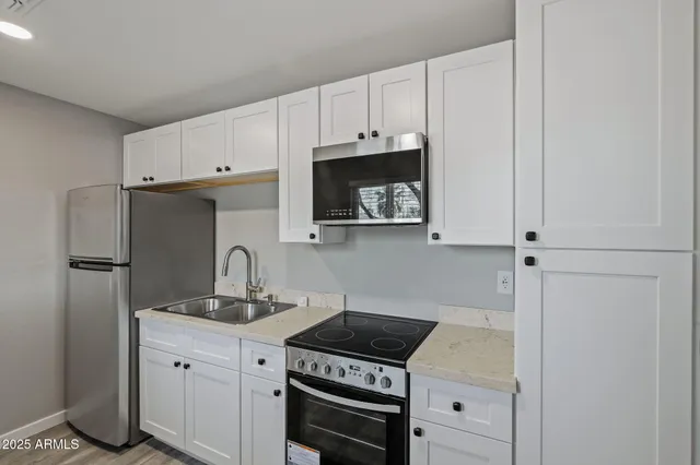 a kitchen with cabinets and a stove top oven