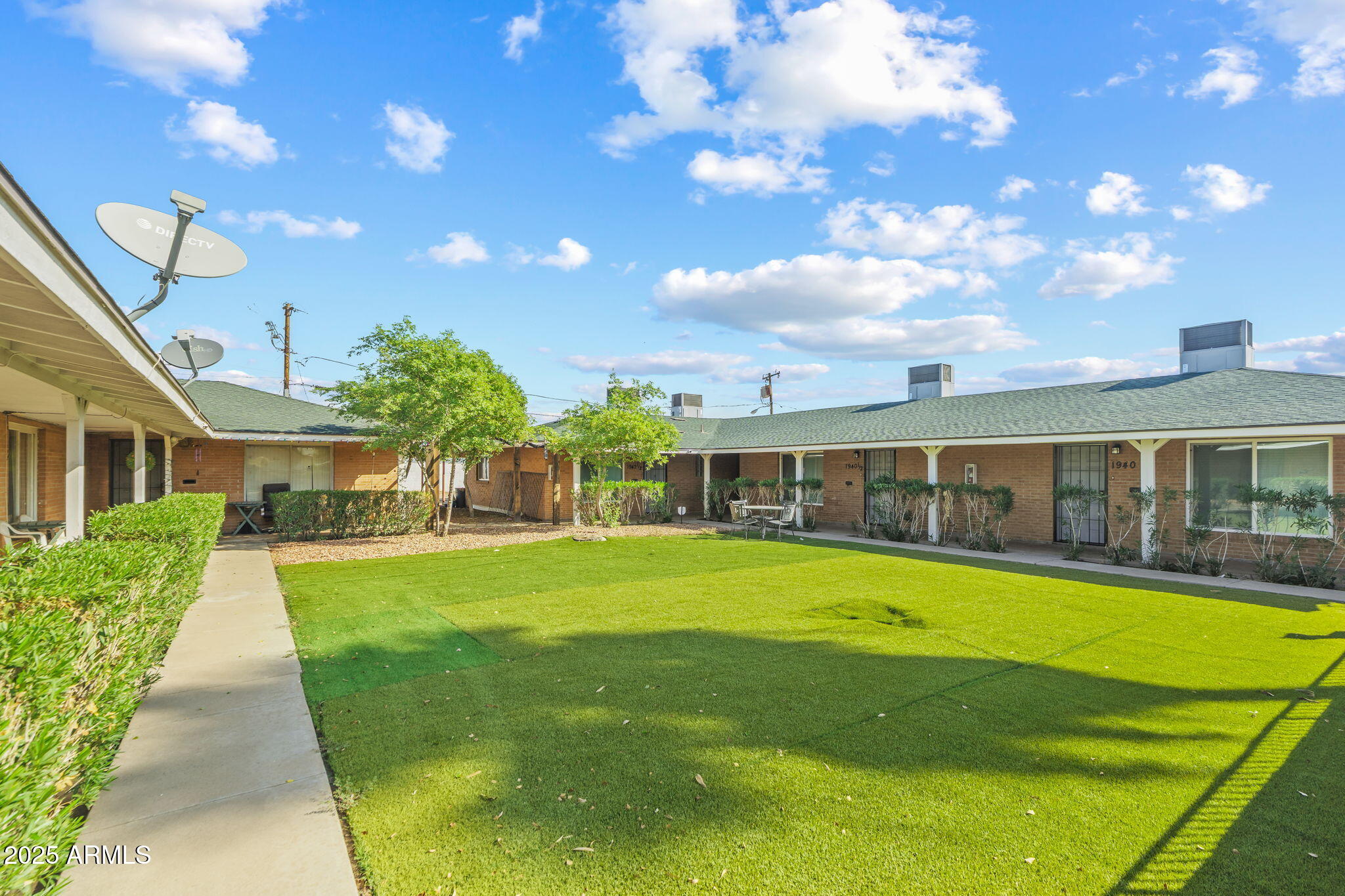 1940 West Amelia Avenue, Unit 1940 Phoenix, AZ 85015 - Photo 2 of 17 a view of a house with a big yard and large trees