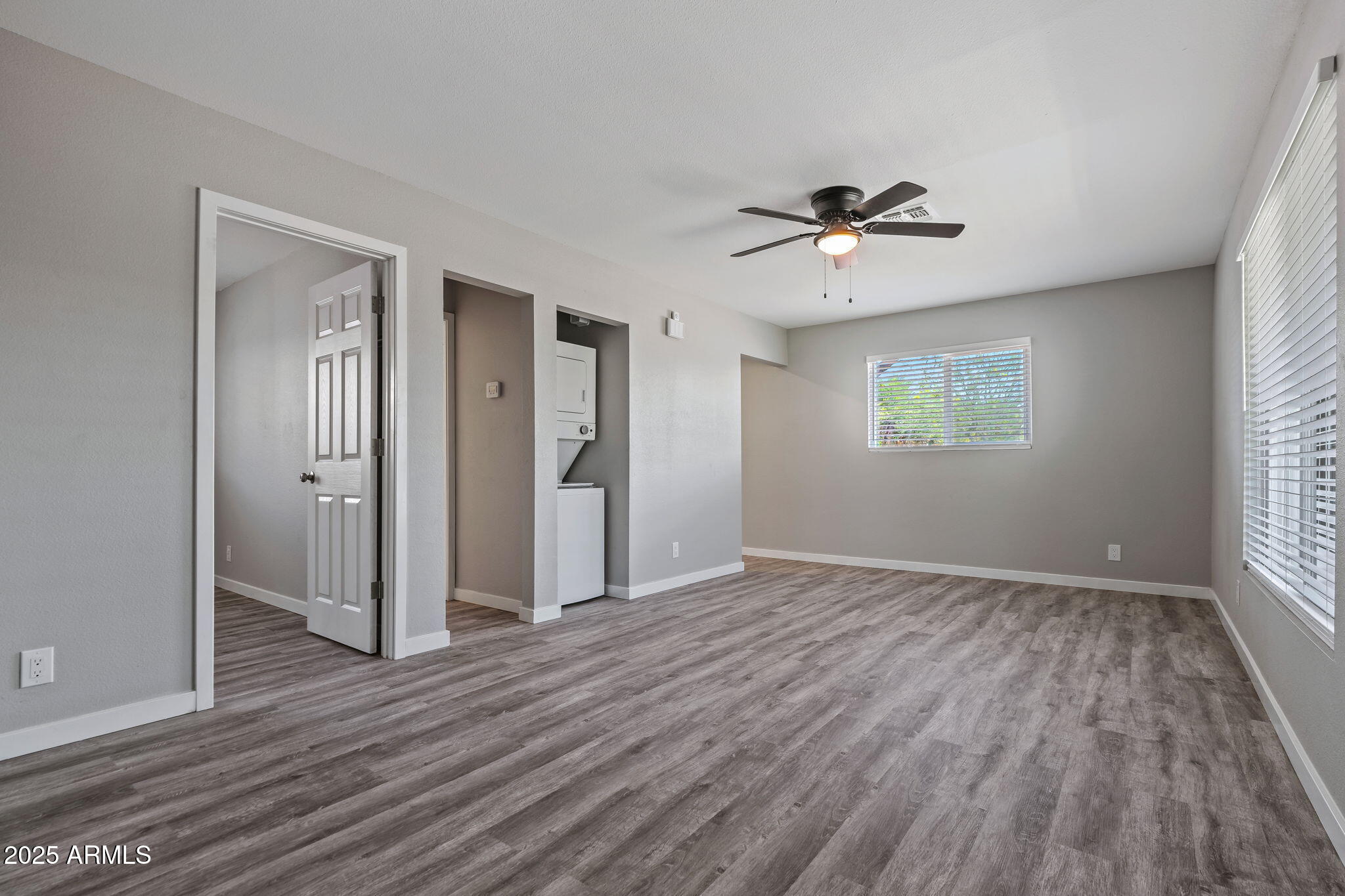 1940 West Amelia Avenue, Unit 1940 Phoenix, AZ 85015 - Photo 6 of 17 wooden floor in an empty room with a window