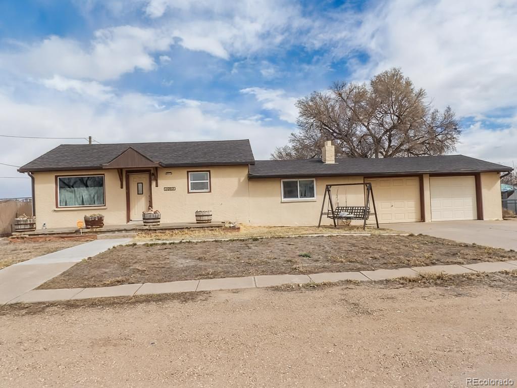 1002 Frontier Street Pueblo, CO 81006 - Photo 19 of 26 a front view of a house with a dirt road and stove