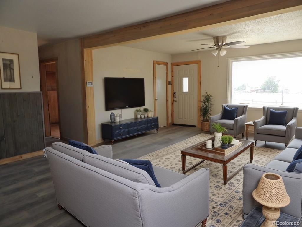1002 Frontier Street Pueblo, CO 81006 - Photo 2 of 26 a living room with furniture and a flat screen tv