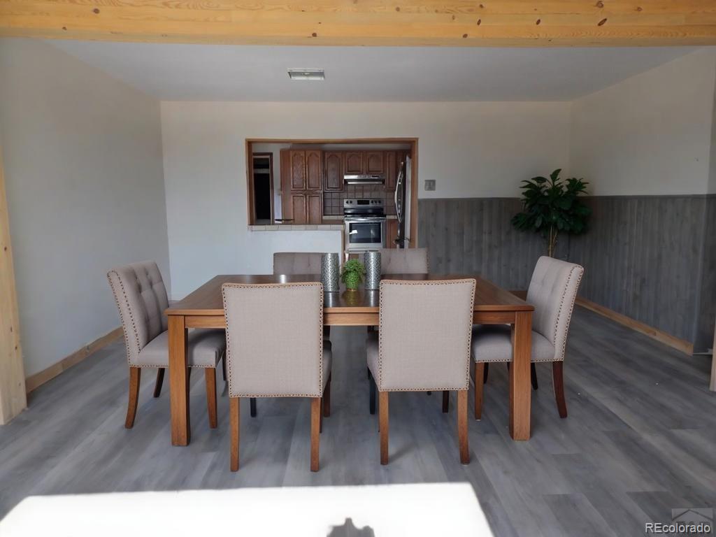 1002 Frontier Street Pueblo, CO 81006 - Photo 3 of 26 a dining room with furniture and wooden floor