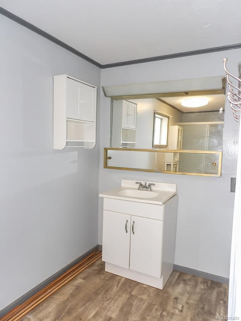 1002 Frontier Street Pueblo, CO 81006 - Photo 9 of 26 a view of a bathroom with a sink and a vanity