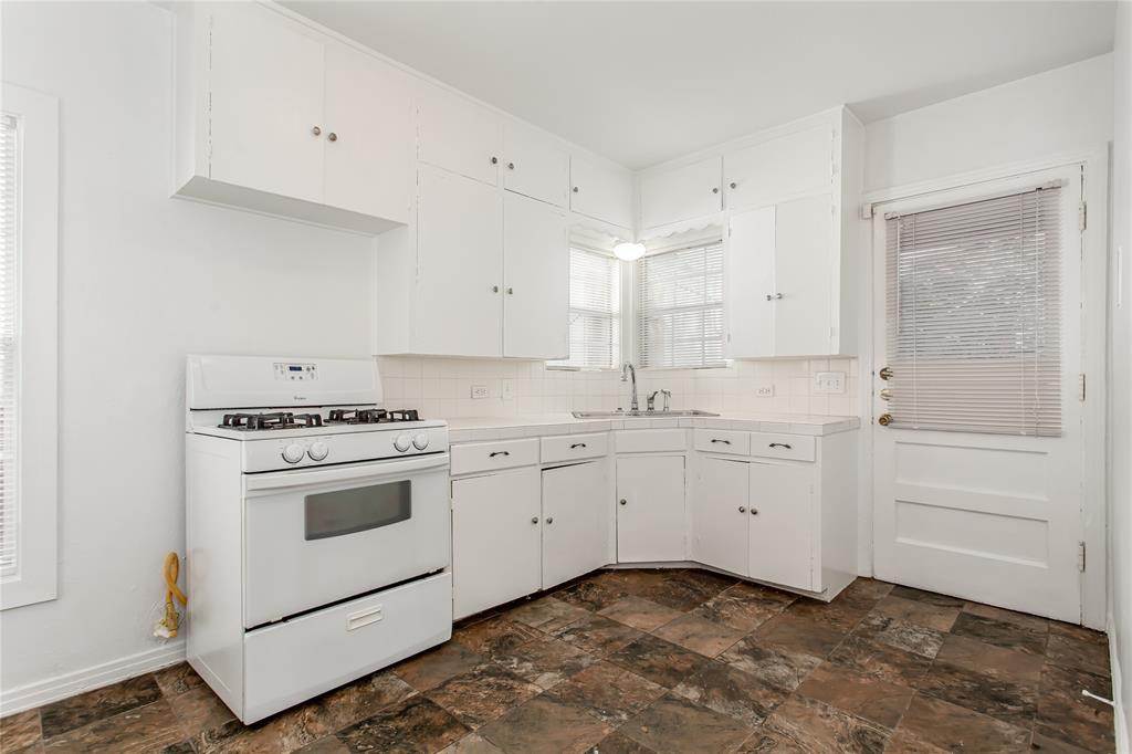 7414 Robin Road Dallas, TX 75209 - Photo 12 of 31 a kitchen with granite countertop cabinets and white stainless steel appliances