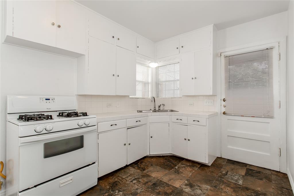 7414 Robin Road Dallas, TX 75209 - Photo 13 of 31 a kitchen with white cabinets appliances and a sink