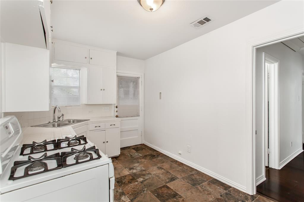 7414 Robin Road Dallas, TX 75209 - Photo 16 of 31 a kitchen with sink stove and cabinets