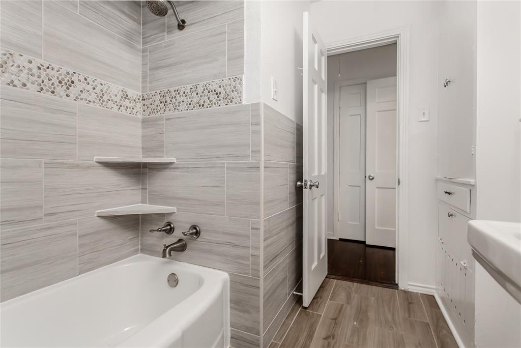 7414 Robin Road Dallas, TX 75209 - Photo 18 of 31 a bathroom with a bathtub and toilet