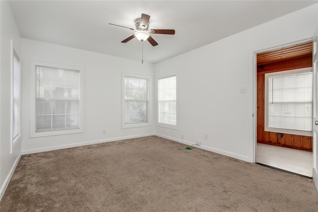 7414 Robin Road Dallas, TX 75209 - Photo 20 of 31 an empty room with chandelier fan and windows