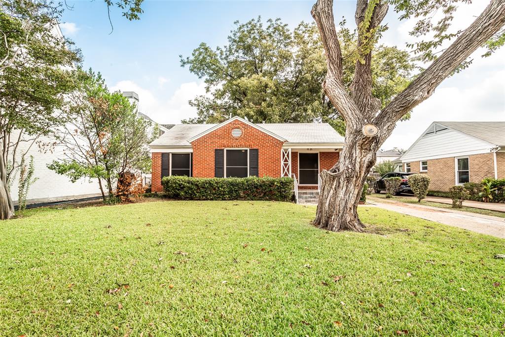 7414 Robin Road Dallas, TX 75209 - Photo 2 of 31 a front view of a house with a yard and trees