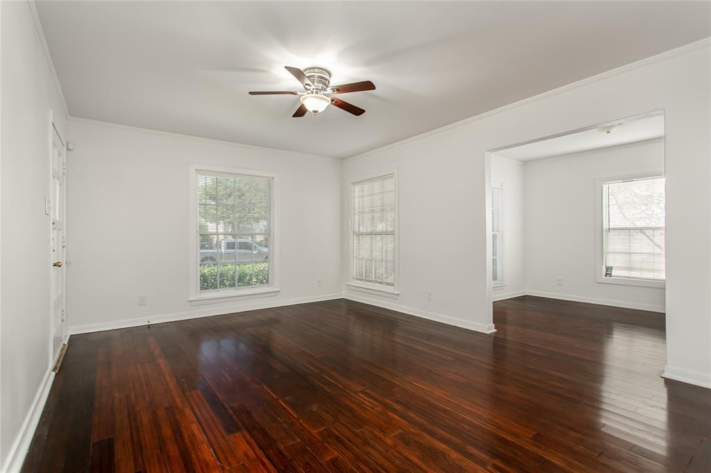 7414 Robin Road Dallas, TX 75209 - Photo 5 of 31 a view of an empty room with wooden floor and a window