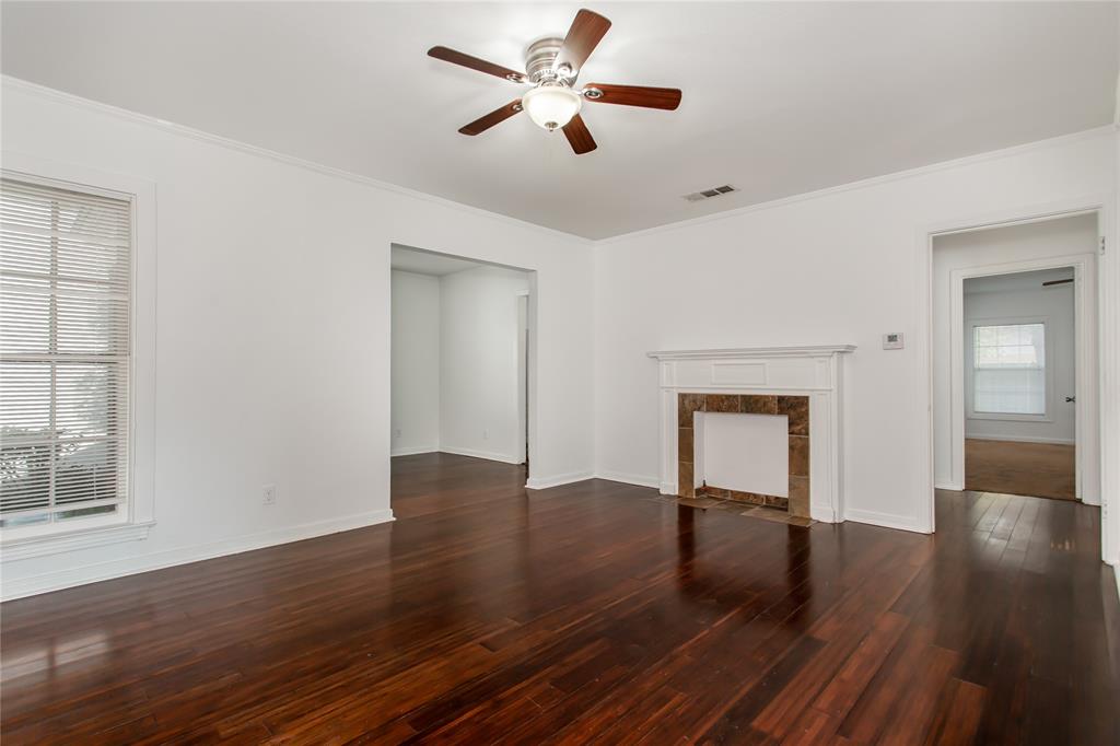 7414 Robin Road Dallas, TX 75209 - Photo 6 of 31 a view of empty room with wooden floor and fan