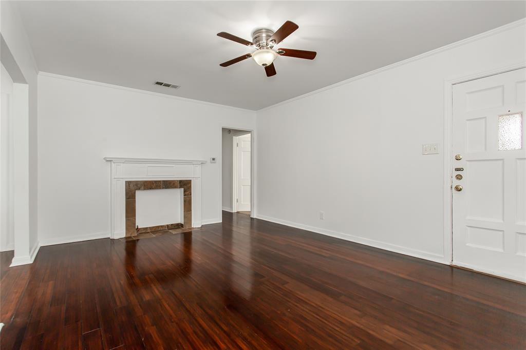 7414 Robin Road Dallas, TX 75209 - Photo 7 of 31 a view of empty room with wooden floor and fan