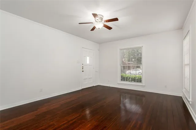 wooden floor in an empty room with a window