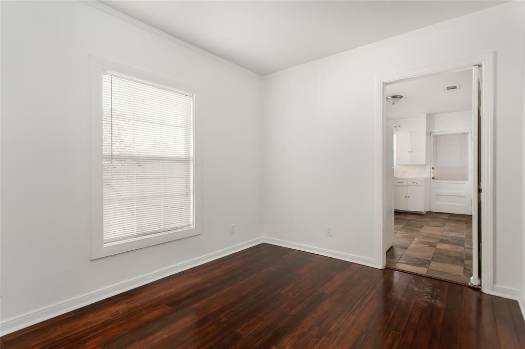 7414 Robin Road Dallas, TX 75209 - Photo 10 of 31 an empty room with wooden floor and a window
