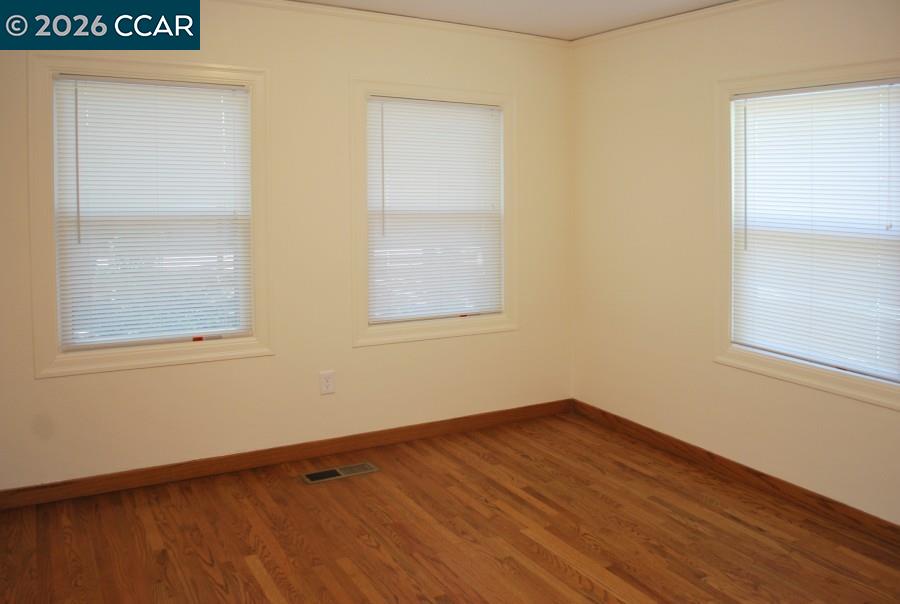 2652 Reliez Valley Road Martinez, CA 94553 - Photo 18 of 34 an empty room with wooden floor and windows