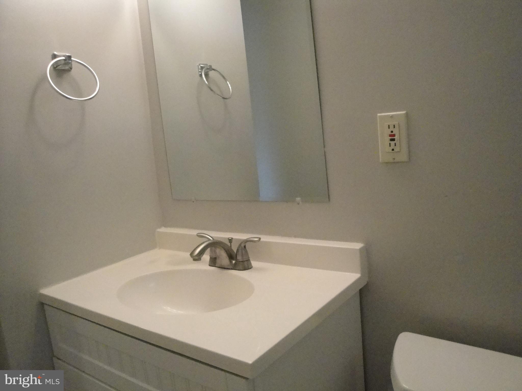 1825 Opalocka Drive McLean, VA 22101 - Photo 24 of 28 a bathroom with a sink a toilet and a mirror