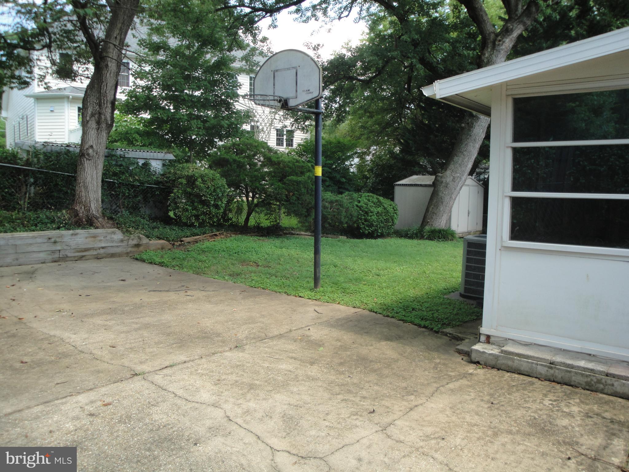 1825 Opalocka Drive McLean, VA 22101 - Photo 6 of 28 a view of a white house with a yard and large tree