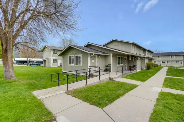 a front view of house with a garden and patio