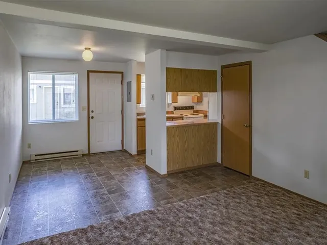 a view of a kitchen with a sink and a refrigerator