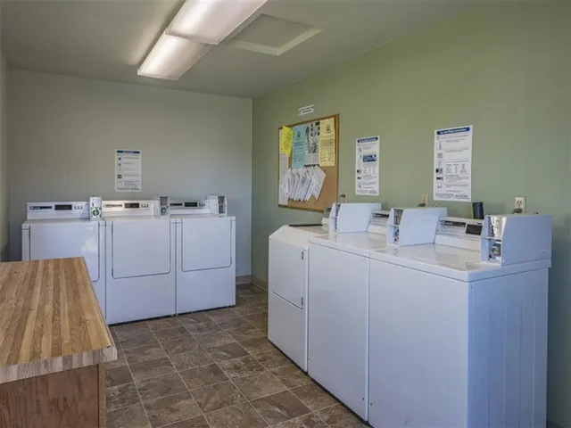 a room with a sink washer and dryer