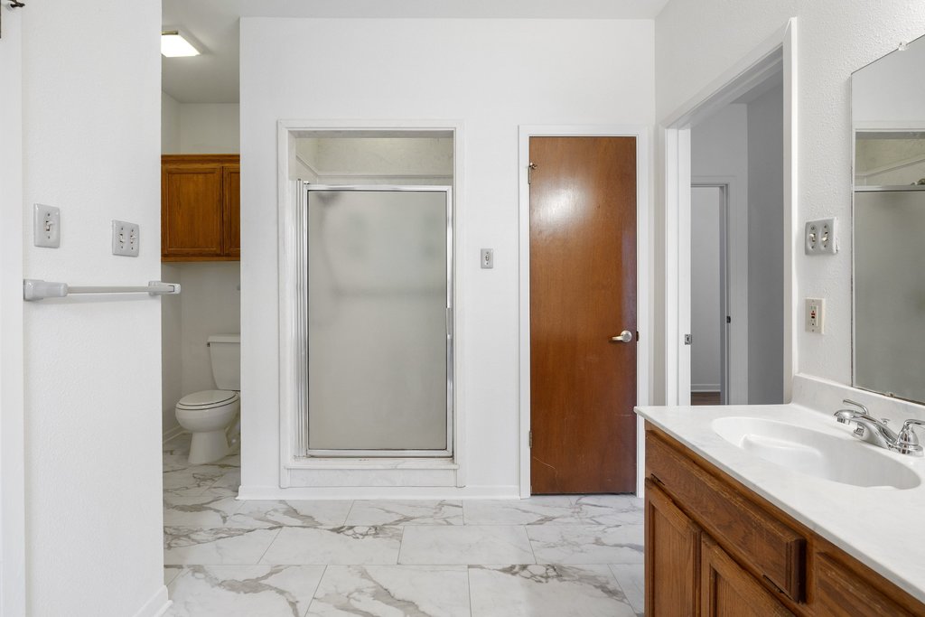 244 Woodway Elgin, TX 78621 - Photo 26 of 40 a bathroom with a sink and a mirror