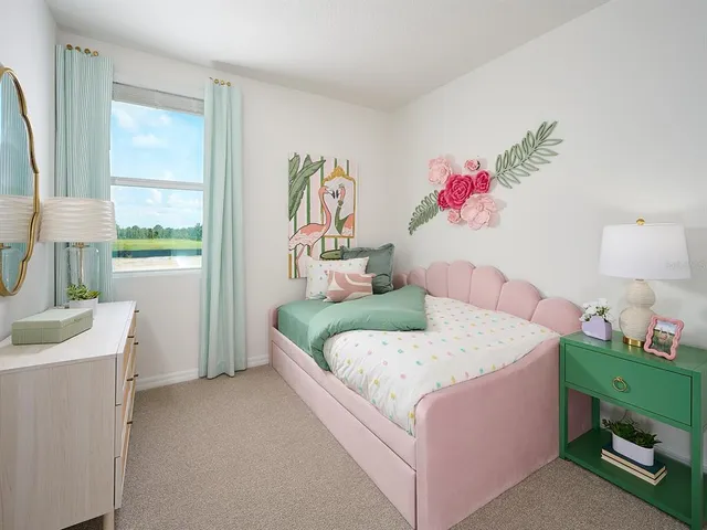 a bedroom with a bed and a dresser next to a window