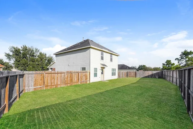 a view of a house with backyard and porch