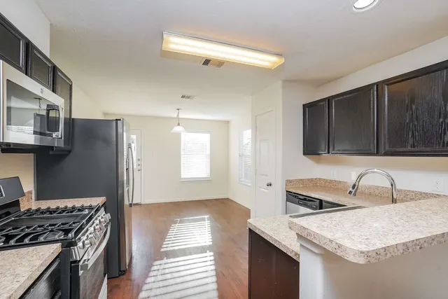 a kitchen that has a sink and a stove