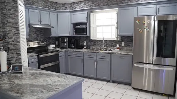 a kitchen with a sink stove and refrigerator