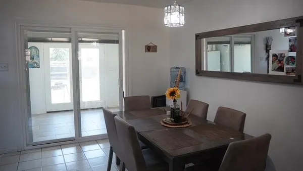 a view of a dining room with furniture and window