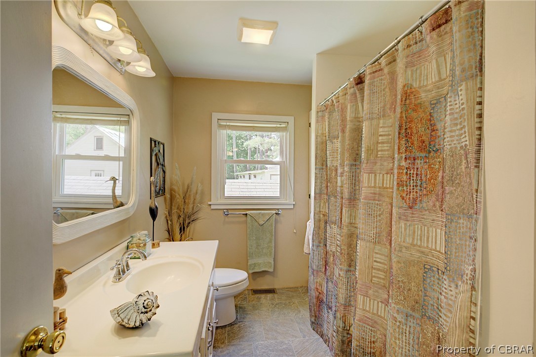 2442 Old Ferry Road Hudgins, VA 23076 - Photo 21 of 33 Bathroom featuring oversized vanity, toilet, and tile floors