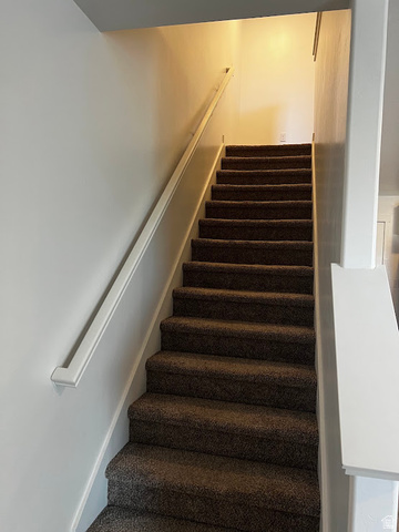 562 Hal Street, Unit 152 Tooele, UT 84074 - Photo 24 of 44 Carpeted staircase featuring a white handrail and light-toned walls