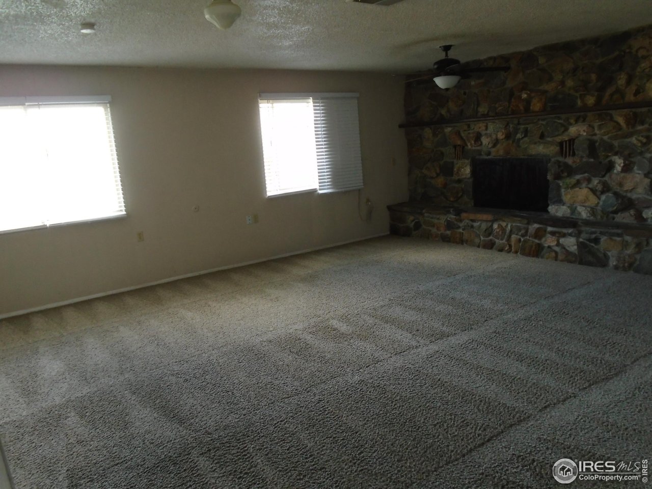 116 Walnut Street Windsor, CO 80550 - Photo 11 of 13 a view of empty room with a fireplace