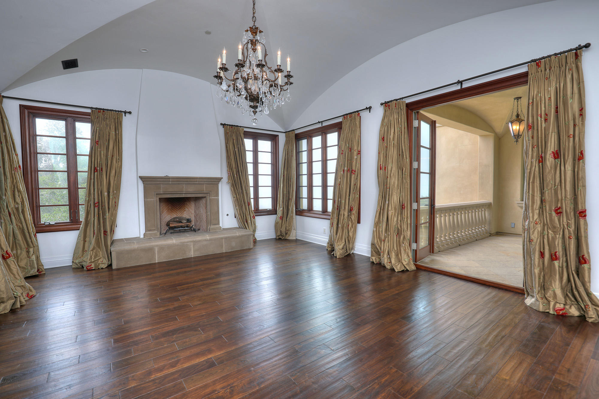 830 Park Lane Montecito, CA 93108 - Photo 21 of 40 an empty room with wooden floor fireplace and windows