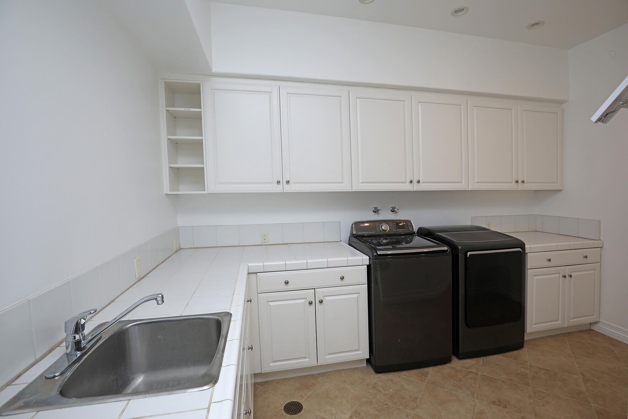830 Park Lane Montecito, CA 93108 - Photo 35 of 40 a kitchen with white cabinets and a sink