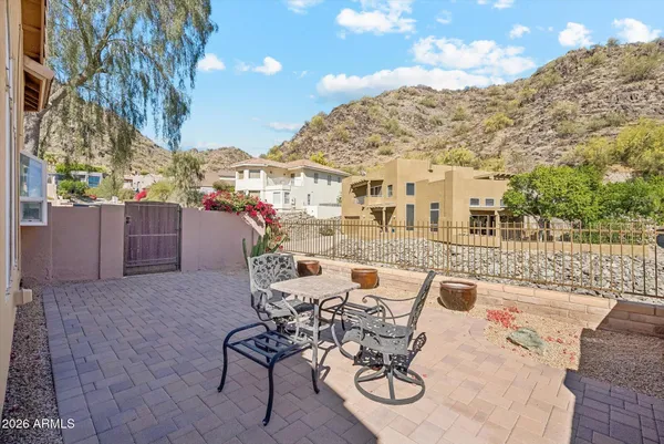 a view of a patio with couches table and chairs and potted plants