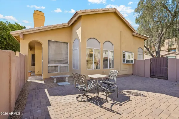 a view of a house with backyard and sitting area