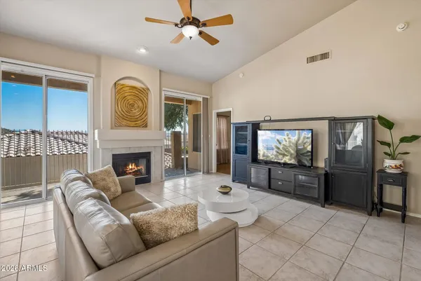 a living room with furniture a fireplace and a flat screen tv