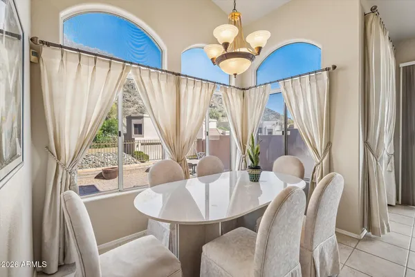 a view of a dining room with furniture wooden floor and chandelier