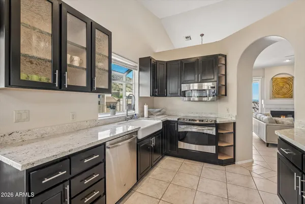a kitchen with stainless steel appliances granite countertop a stove and a sink