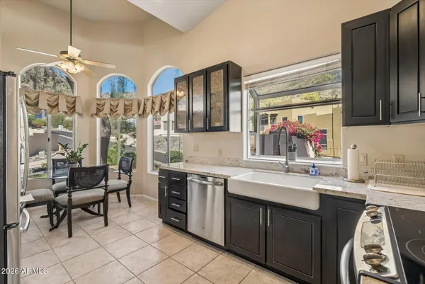 a kitchen with stainless steel appliances granite countertop a sink and cabinets