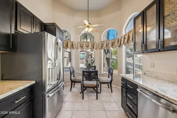 a kitchen with stainless steel appliances granite countertop a refrigerator and a sink
