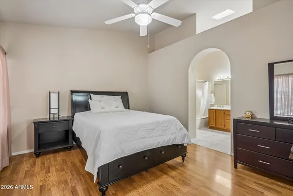 a bedroom with a bed and dresser with mirror