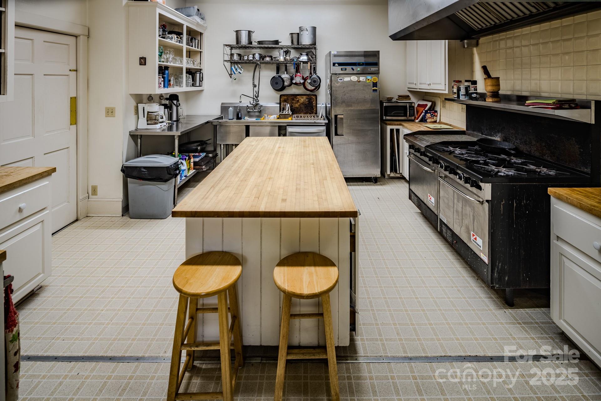 4584 Highway 194 Sugar Grove, NC 28679 - Photo 15 of 48 a kitchen with granite countertop a table chairs stove and cabinets